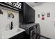 Well-organized laundry room with overhead cabinets, stylish decor, and a front-load washer and dryer at 15675 Woodford Dr, Westfield, IN 46074