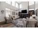 Bright living room with soaring ceilings, a cozy fireplace, large windows, and stylish decor at 15675 Woodford Dr, Westfield, IN 46074