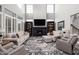 Bright and airy living room with a fireplace, tall windows, and comfortable seating at 15675 Woodford Dr, Westfield, IN 46074