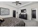 Spacious main bedroom with a tray ceiling, a ceiling fan, and a black dresser with a TV at 15675 Woodford Dr, Westfield, IN 46074