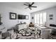 Inviting home office with a ceiling fan, custom desk, and cozy seating area at 15675 Woodford Dr, Westfield, IN 46074