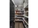 Walk-in pantry with ample storage space and well-stocked shelving at 15675 Woodford Dr, Westfield, IN 46074