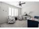 Inviting sitting room with comfortable armchairs, shutters, and a ceiling fan at 15675 Woodford Dr, Westfield, IN 46074