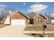 Charming brick home featuring a two-car garage, a well-manicured lawn, and a cozy front porch at 160 Tracy Ridge Blvd, Whiteland, IN 46184