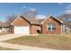 Charming single-story brick home with a two-car garage and a well-maintained front yard at 160 Tracy Ridge Blvd, Whiteland, IN 46184