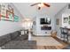 Inviting living room with gray sectional sofa, modern decor, and wood flooring at 160 Tracy Ridge Blvd, Whiteland, IN 46184