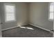 Comfortable bedroom with carpet, baseboard trim, and ample natural light at 1624 S Jersey Ave, Muncie, IN 47302