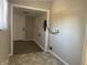 This hallway has tile and carpet flooring and a white front door at 1624 S Jersey Ave, Muncie, IN 47302