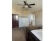 Bedroom featuring a ceiling fan, neutral carpet, and a glimpse into an adjoining space at 203 Village Green Dr, Indianapolis, IN 46227