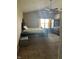 Spacious bedroom with a ceiling fan, neutral carpet, and a large window, offering ample natural light at 203 Village Green Dr, Indianapolis, IN 46227