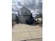 Two-story home featuring a two car garage, and a driveway with space for parking at 203 Village Green Dr, Indianapolis, IN 46227