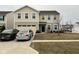 Charming two-story home featuring an attached garage and well-maintained front yard and two parked cars at 215 Traditions Pass, Greenwood, IN 46143