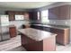Kitchen featuring stainless steel appliances, dark cabinets, and an island at 215 Traditions Pass, Greenwood, IN 46143