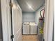 A bright laundry room featuring a modern washer and dryer set with tile flooring at 215 Traditions Pass, Greenwood, IN 46143