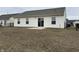 Backyard featuring a chain-link fence, sliding glass door and small patio at 2399 Orchard Creek Dr, Columbus, IN 47201