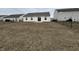 Backyard featuring a chain-link fence, sliding glass door and small patio at 2399 Orchard Creek Dr, Columbus, IN 47201