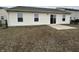 Backyard featuring a chain-link fence, sliding glass door and small patio at 2399 Orchard Creek Dr, Columbus, IN 47201