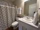 Well-lit bathroom featuring a patterned shower curtain, white vanity, decorative accents, and ample counter space at 2399 Orchard Creek Dr, Columbus, IN 47201