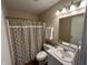 Charming bathroom with patterned shower curtain, white vanity, decorative accents, and ample lighting for a fresh ambiance at 2399 Orchard Creek Dr, Columbus, IN 47201