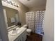 Cozy bathroom with large mirror, chevron-patterned shower curtain, and bright cabinets at 2399 Orchard Creek Dr, Columbus, IN 47201