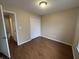 Bright bedroom featuring wood-look floors, neutral walls, and a spacious closet, creating a cozy atmosphere at 2399 Orchard Creek Dr, Columbus, IN 47201