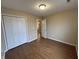 Inviting bedroom featuring wood-look floors, neutral walls, and a spacious closet, creating a cozy retreat at 2399 Orchard Creek Dr, Columbus, IN 47201