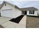 Charming single-story home featuring an attached garage and well-maintained landscaping at 2399 Orchard Creek Dr, Columbus, IN 47201