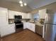 Bright kitchen features white cabinets, stainless steel appliances, and modern lighting at 2399 Orchard Creek Dr, Columbus, IN 47201