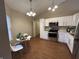 Bright kitchen features white cabinets, stainless steel appliances, and modern lighting at 2399 Orchard Creek Dr, Columbus, IN 47201