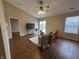Bright living room featuring hardwood floors, ceiling fan, and sliding glass doors to a patio at 2399 Orchard Creek Dr, Columbus, IN 47201