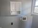 A neutral gray wall with utility connections and a white cabinet adds a touch of functionality at 2905 N Barr St, Muncie, IN 47303
