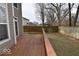 Wooden back deck provides an outdoor space with views of the fenced yard, perfect for relaxing and entertaining at 3258 Starlite Ct, Columbus, IN 47203