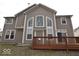 Back of house features a large deck, multiple windows for natural light, and a well-maintained yard at 3258 Starlite Ct, Columbus, IN 47203