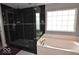 Modern black tiled shower and bathtub in a naturally lit bathroom with sleek fixtures at 3258 Starlite Ct, Columbus, IN 47203