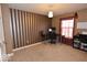 Bedroom with striped accent wall features a desk, window, and carpeted floor, creating a cozy and functional space at 3258 Starlite Ct, Columbus, IN 47203