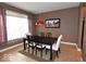 Modern dining room featuring neutral tile floors, a dark wood table, and a striking red pendant light at 3258 Starlite Ct, Columbus, IN 47203