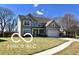 Charming two-story home with a well-manicured lawn and attached two car garage at 3258 Starlite Ct, Columbus, IN 47203