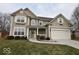 Charming two-story home features a well-manicured lawn, attached garage, and welcoming covered porch at 3258 Starlite Ct, Columbus, IN 47203