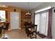 Cozy kitchen nook with a dining table, large window, and access to the patio at 3258 Starlite Ct, Columbus, IN 47203