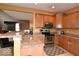 Open kitchen layout with a breakfast bar, stainless steel appliances, and ample cabinet space at 3258 Starlite Ct, Columbus, IN 47203