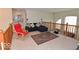 Open loft area with a comfortable lounge chair, soft carpet, and stylish furnishings at 3258 Starlite Ct, Columbus, IN 47203