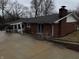 Backyard exterior shows the brick home, covered patio, and large concrete pad at 326 W State Road 42, Mooresville, IN 46158
