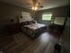 Comfortable bedroom featuring a ceiling fan, cozy quilt, and natural light from the window at 326 W State Road 42, Mooresville, IN 46158