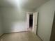 This bedroom features neutral walls and carpet with a door with access to other parts of the house at 326 W State Road 42, Mooresville, IN 46158