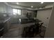 Modern kitchen with gray cabinets, island with cooktop, and stainless steel appliances at 326 W State Road 42, Mooresville, IN 46158