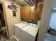 A laundry room is shown with cabinets, washer, dryer, and toilet at 326 W State Road 42, Mooresville, IN 46158