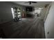 Open-concept living room with modern flooring, ceiling fan, and convenient access to the kitchen at 326 W State Road 42, Mooresville, IN 46158