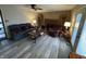 Cozy living room featuring hardwood floors, a fireplace, comfortable seating, and ample natural light at 326 W State Road 42, Mooresville, IN 46158