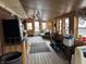 An unfinished sun room features a ceiling fan, windows, and wood floor at 326 W State Road 42, Mooresville, IN 46158