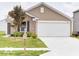 Beautifully maintained home with an attached garage and a well-kept lawn at 3693 Berkdale Dr, Columbus, IN 47203